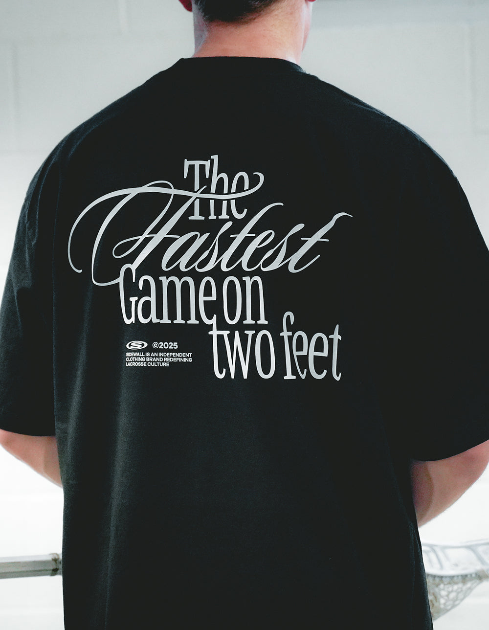 Fastest Game black lacrosse tee back graphic lifestyle