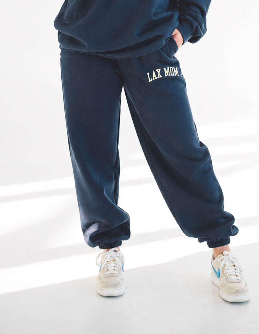 Lax Mom navy sweatpants on model