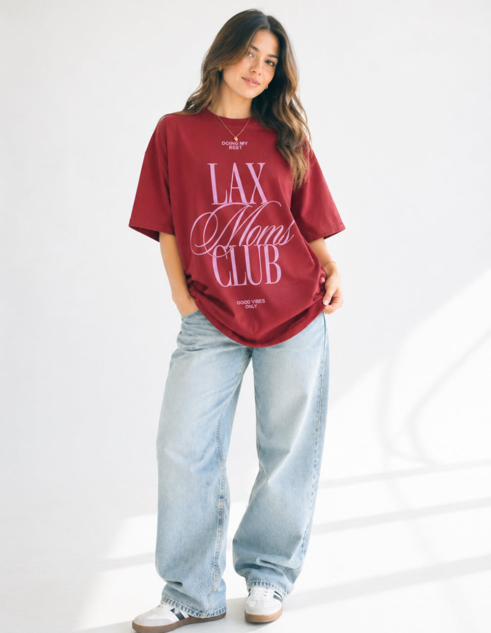 Lax Mom Club red oversized tee on model